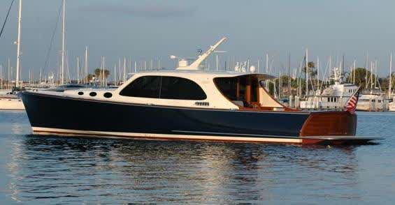 Navy Hinckley-style picnic boat with teak transom and American flag